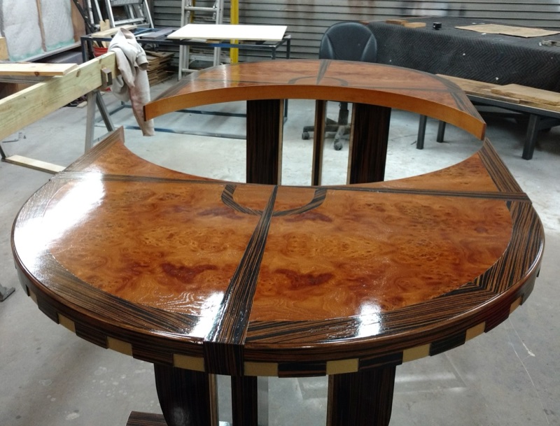 The finished high-gloss Art Deco extension table in figured burl with radiating inlay, by Van Aken Design