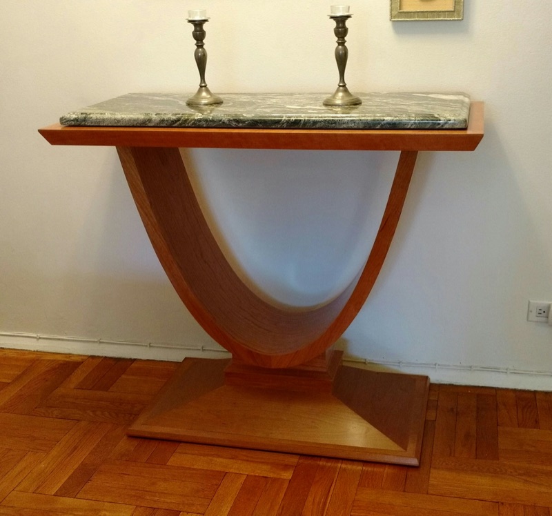 Sculpted oak console table with a curved candlestick-shaped pedestal and a marble top, custom built by Van Aken Design