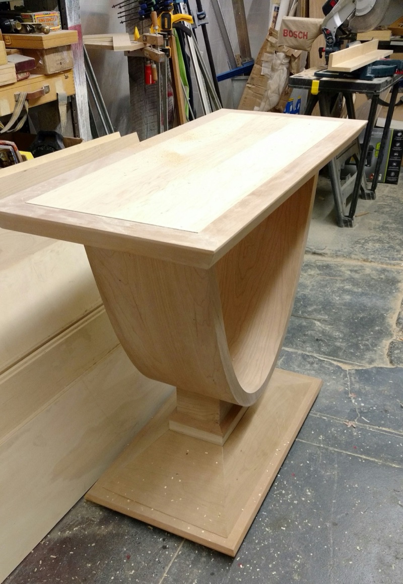A side table hand-shaped in raw oak in the Van Aken Design workshop, before finishing