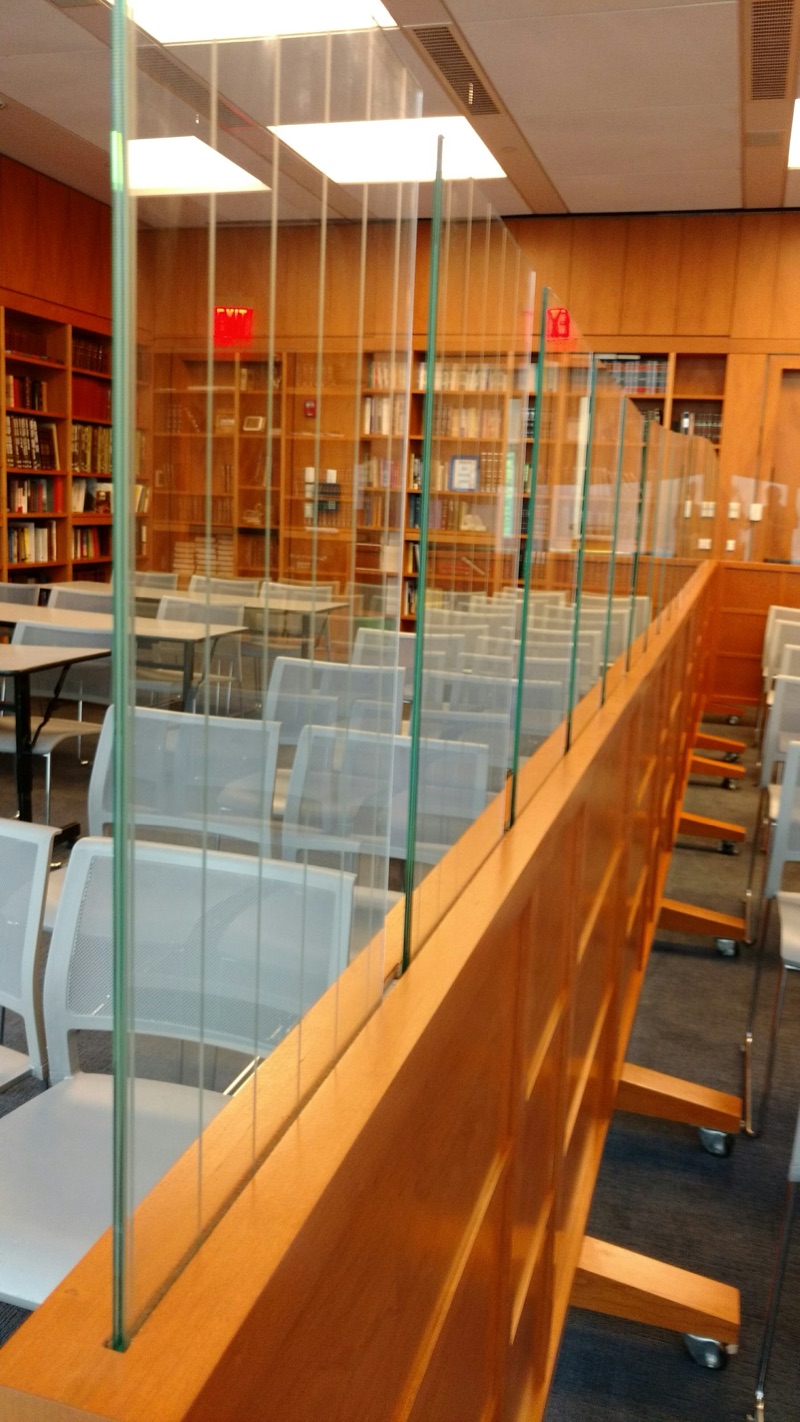 Glass-panelled partition set into custom wood cabinetry in a synagogue sanctuary by Van Aken Design